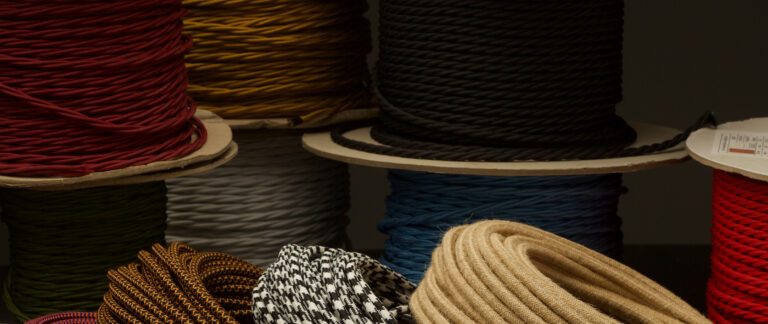 Spools of colored fabric covered lighting cable